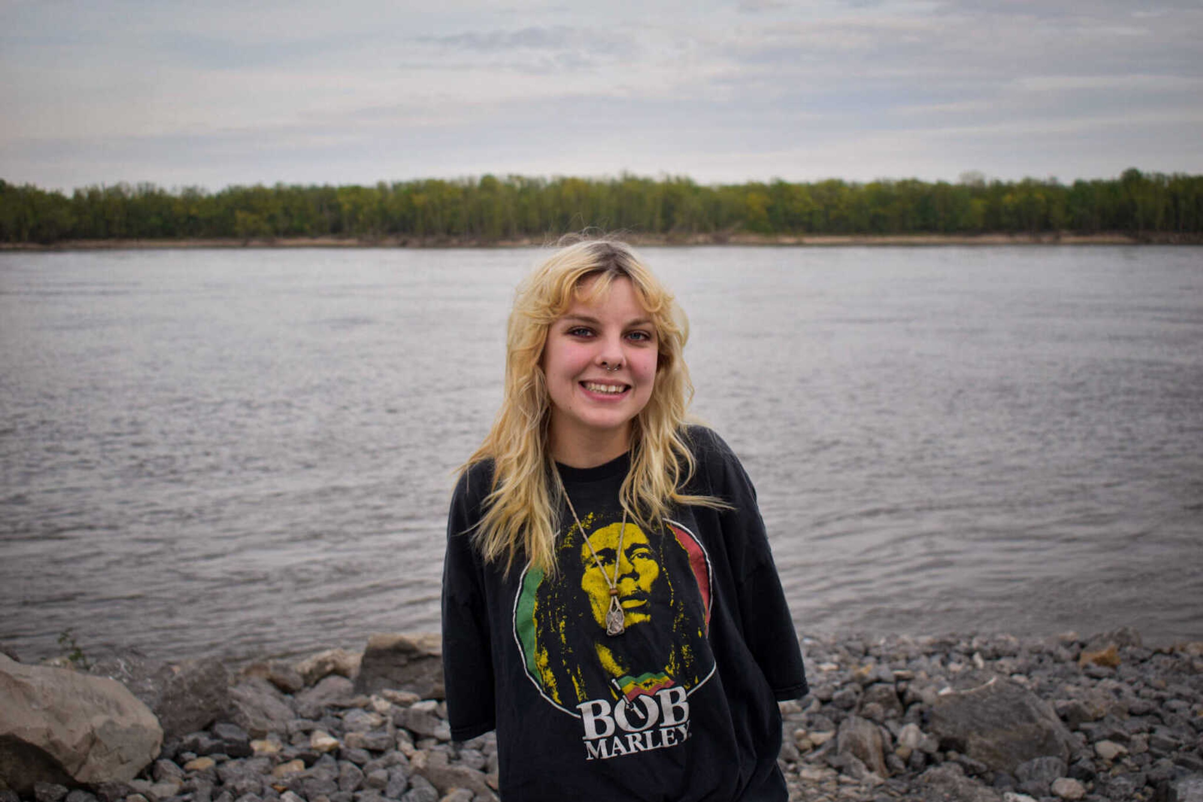 Morgan Proffer, the founder of the Cape Cleanup organization, poses for a photo in front of the Mississippi River.