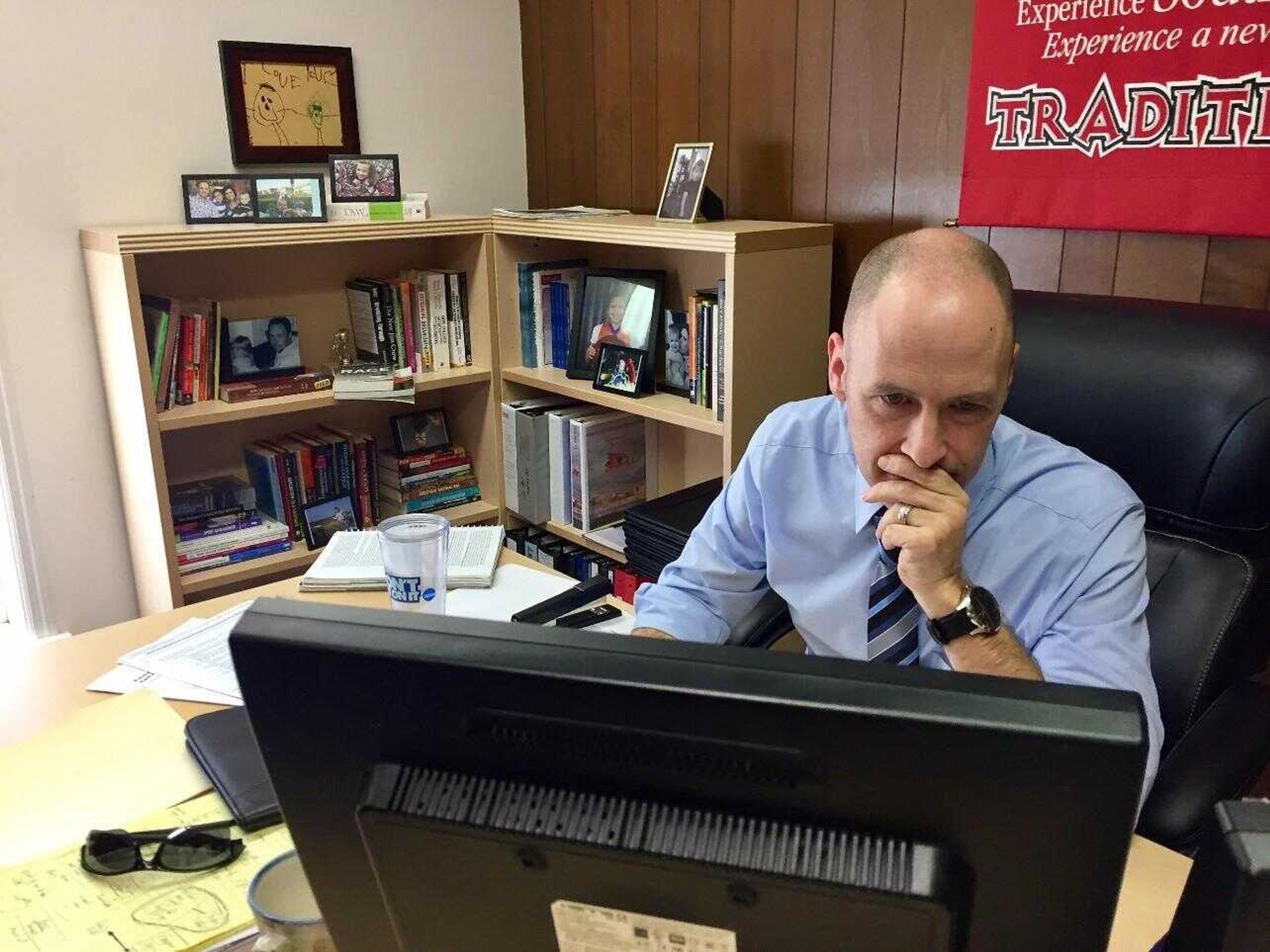 Newly hired assistant director of athletics for compliance and eligibility Dr. Robert Greim works at his new office in the building of athletics administration.