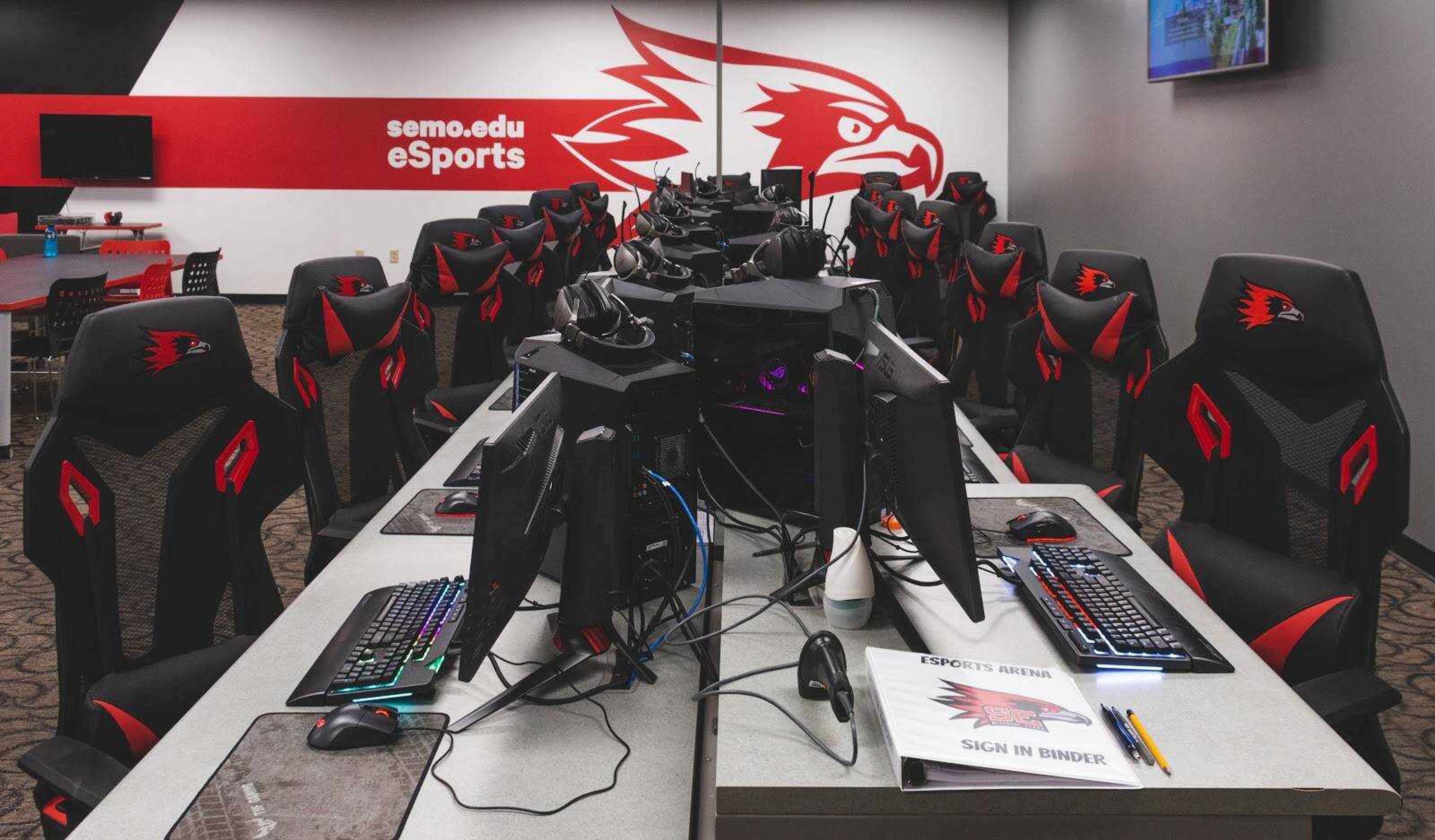 Gaming chairs and personal computers line a table at Southeast’s eSports Arena in the Towers Complex in Cape Girardeau, Missouri. 