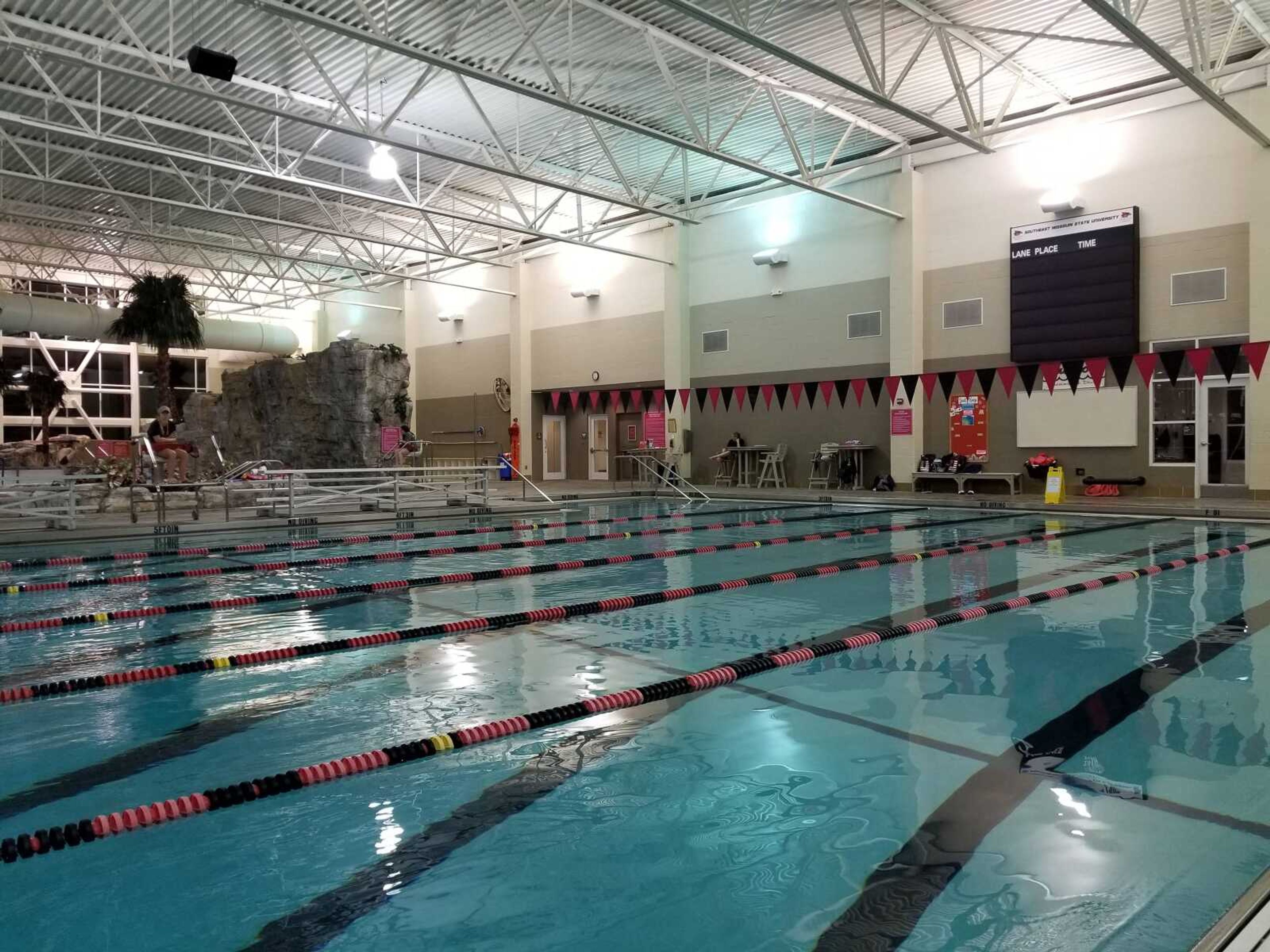 The Student Aquatic Center sits calmly as life guards look over the pool.