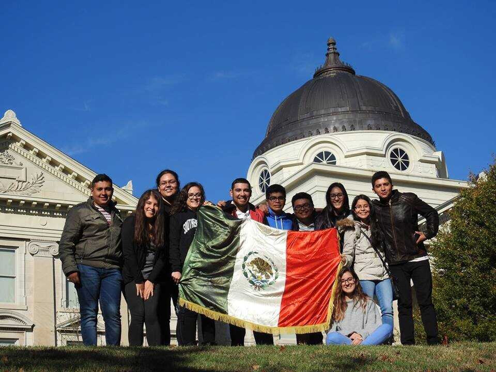 Posing with their homeland flag these 11 students from the 100,000 in the Americas Initiative will call Southeast home until Nov. 17.