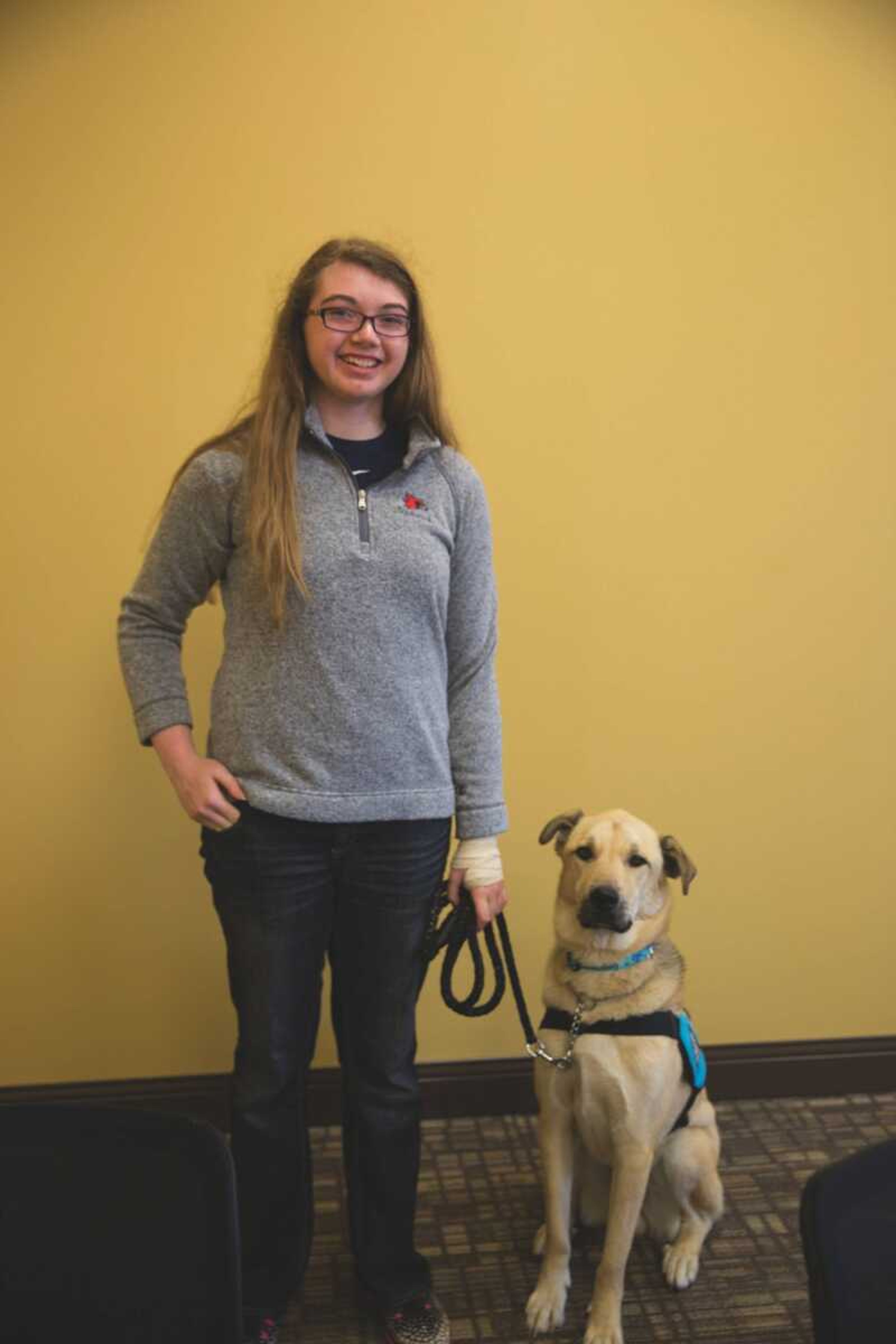 Marissa New poses with her service dog, Creed, in Academic Hall.