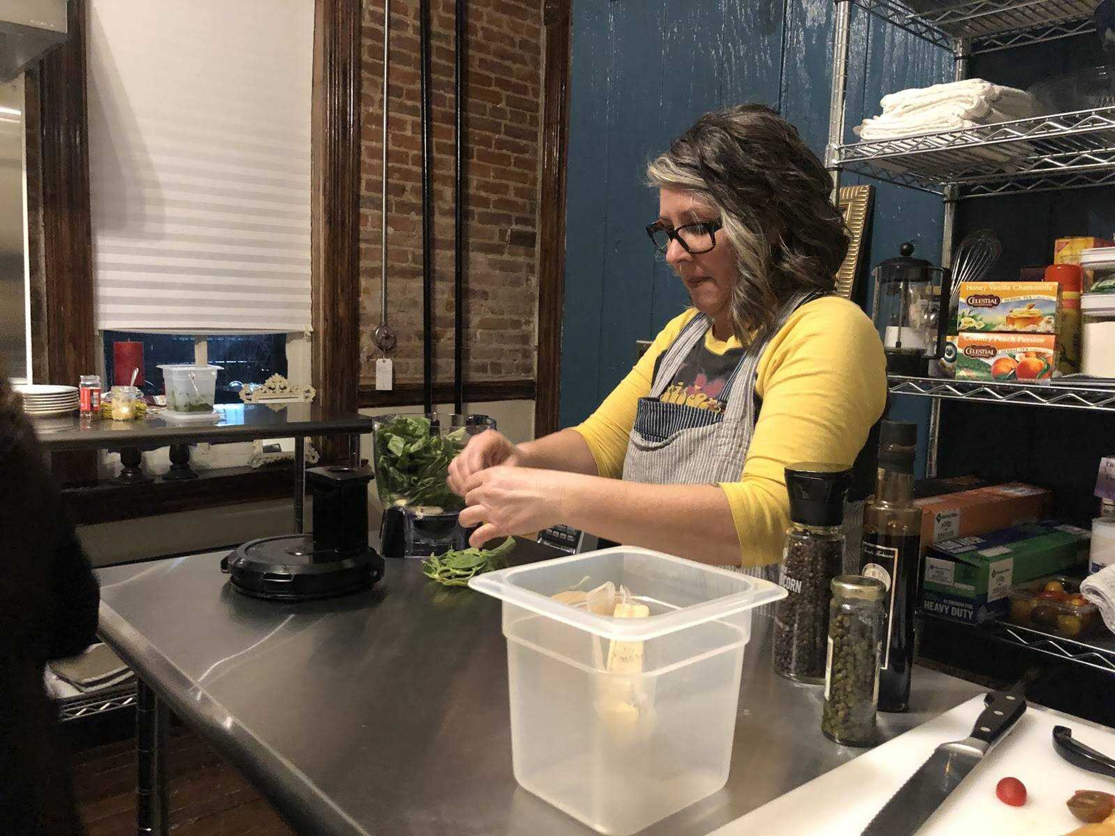 Lisa Essmyer prepares basil in her F&#363;dio kitchen at the Indie House as part of the First Friday event on Feb. 7 in Cape Girardeau.