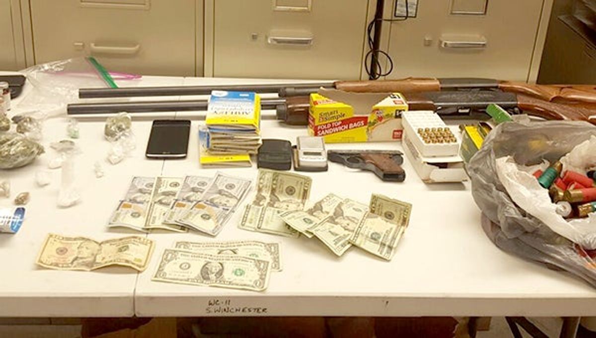 Raid nets guns, drugs and cash