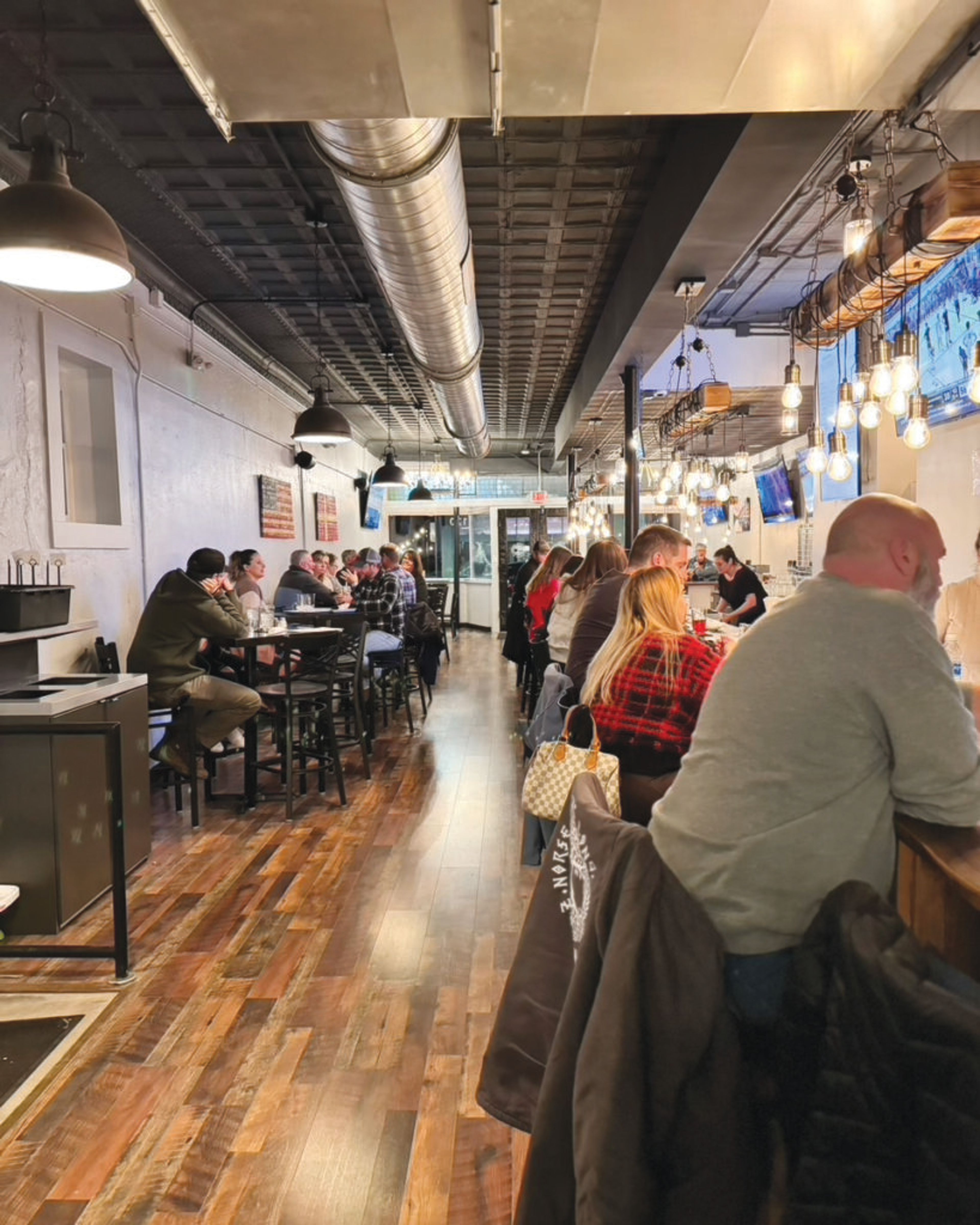 Patrons enjoy food and beverage at Norse Brewing Longhouse in Zebulon. Contributed photo
