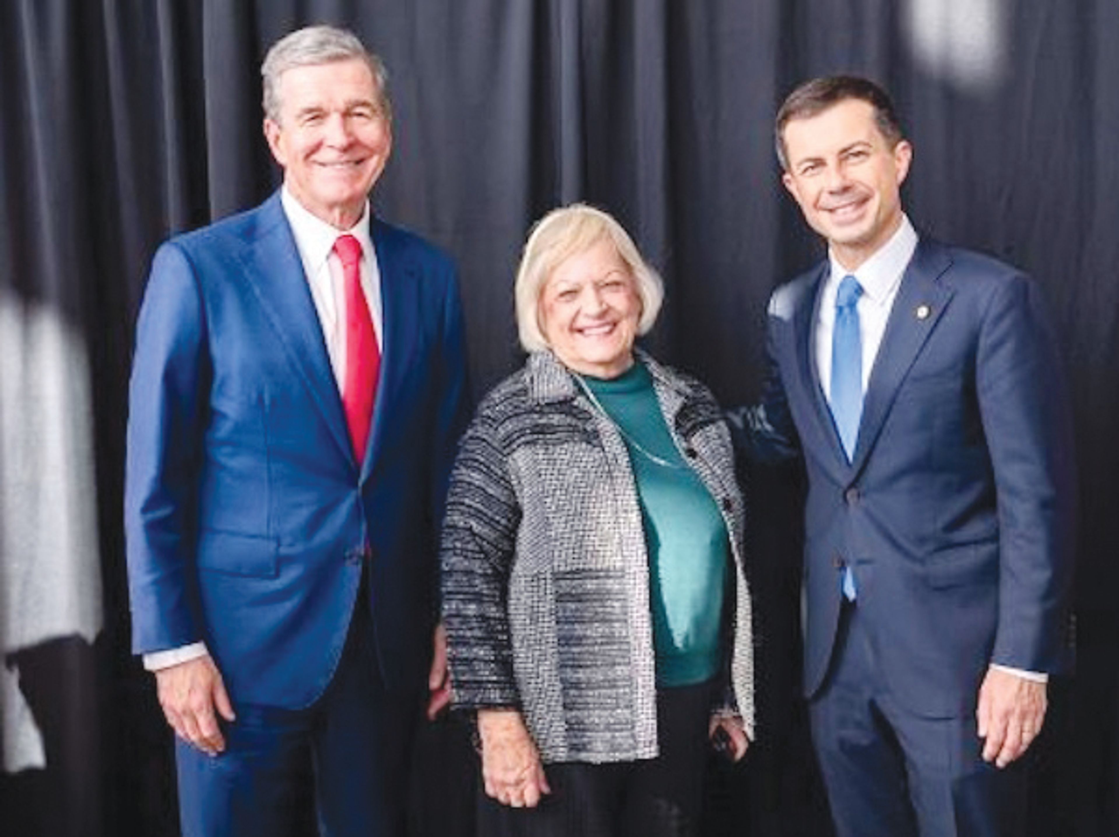 Celebrating the federal funding for the new Raleigh to Richmond rail project, from left, are N.C. Gov. Roy Cooper,  Wake Forest Mayor Vivian Jones, and U.S. Transportation Sec. Pete Buttigieg. | Contributed photo