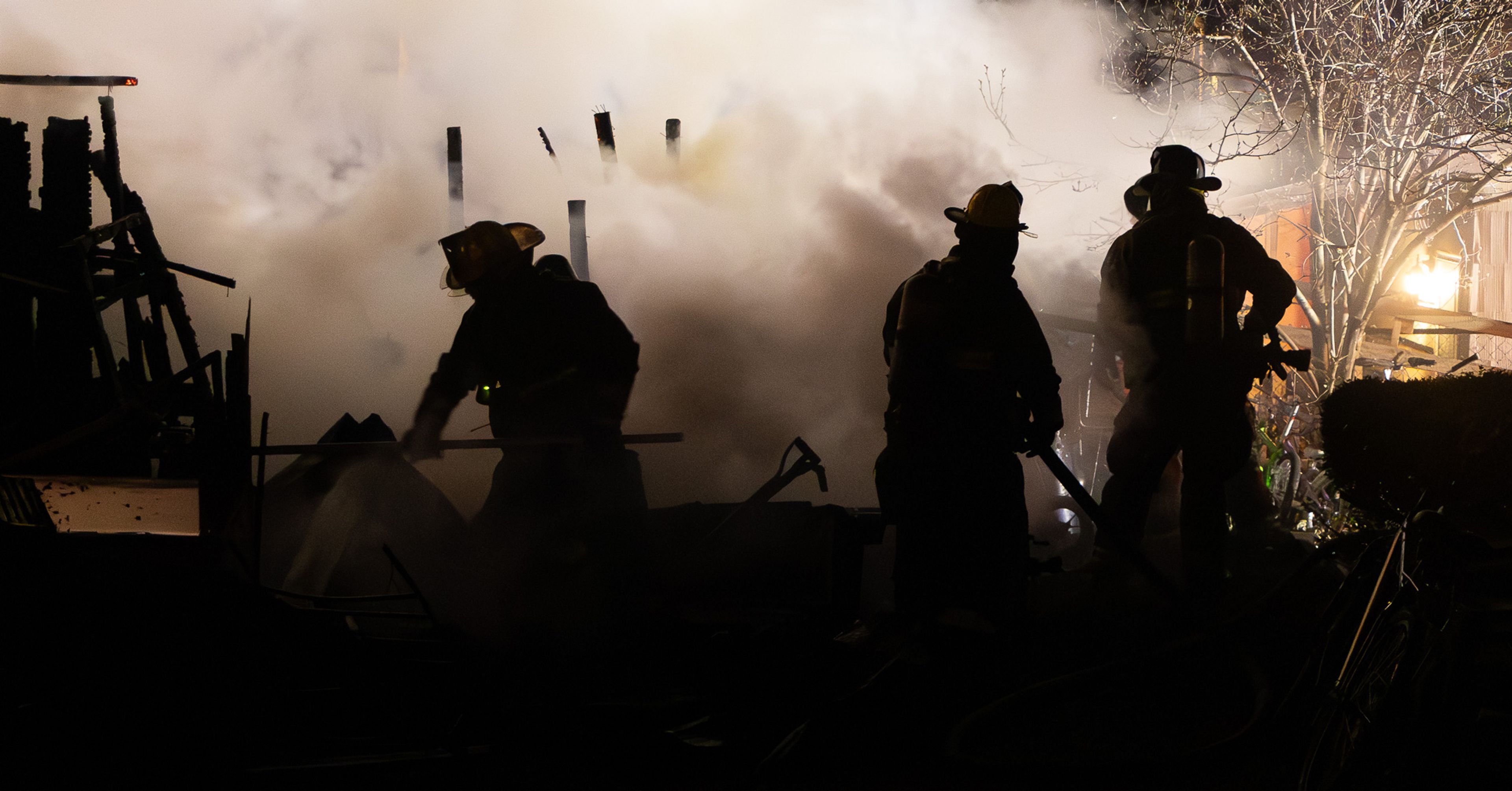 Firefighters move through heavy smoke while overhauling debris after the shed fire was brought under control behind a Magnolia Street home. (photos S Jason Cole) Firefighters work to knock down an intense storage shed fire behind a home at 1018 Magnolia Street on Sunday night, Jan. 4, as heavy smoke and flames threatened nearby structures. Heat from the shed fire melted vinyl siding and caused exterior damage to a nearby home, leaving warped and charred materials along the back of the structure. Quick acting teens help save the day: Brodie Killion, Jayce Clevenger, Sophie Loy, Layla Mandl, Kloey Richardson, and Alana Loy alerted neighbors and called 911. A firefighter carries a cat rescued from the Kevin Street home after crews searched the smoke-filled residence following the basement fire. A firefighter stands by as investigators and crew members assess conditions outside the Kevin Street home after the fire was brought under control. Assistant Fire Chief Cam White communicates over a radio while coordinating operations at the Kevin Street house fire.